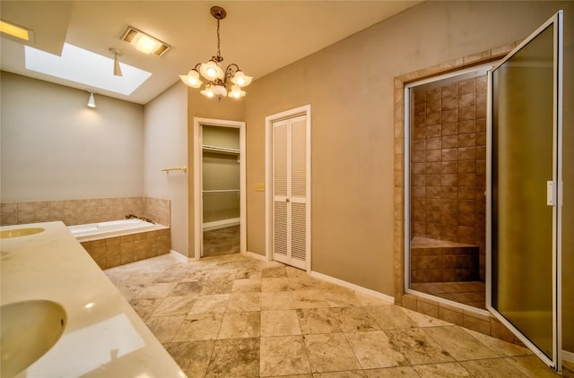 bathroom with vanity, separate shower and tub, and an inviting chandelier