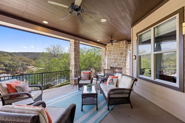 view of terrace with an outdoor hangout area, ceiling fan, and a balcony