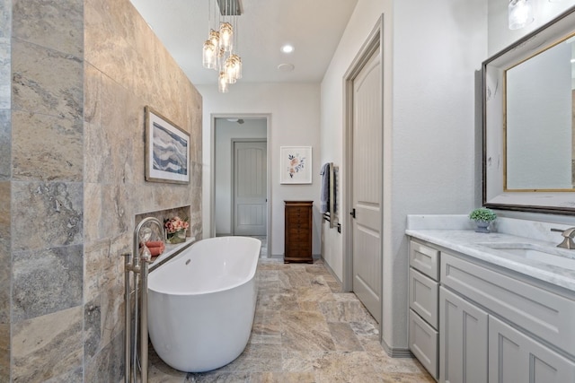 bathroom featuring a tub, tile walls, vanity, and tile flooring