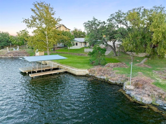 dock area with a water view and a yard