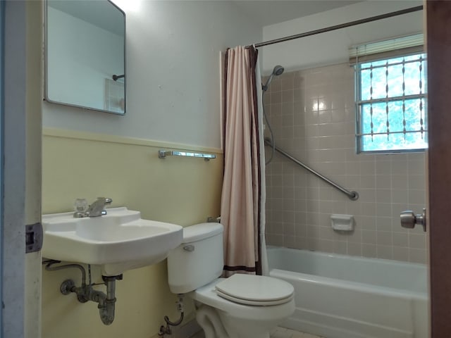 bathroom featuring toilet and shower / bath combo