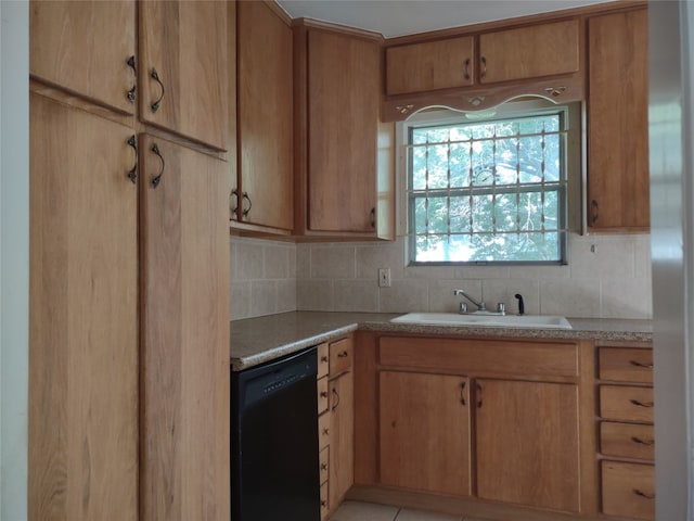 kitchen featuring dishwasher, sink, and tasteful backsplash