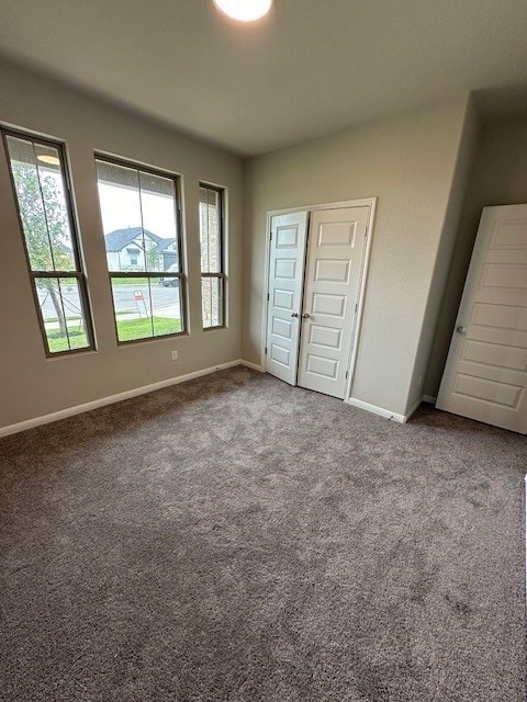 unfurnished bedroom with a closet and carpet