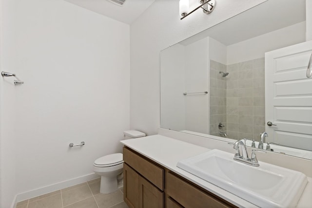 full bathroom featuring tile patterned floors, toilet, vanity, and tiled shower / bath combo