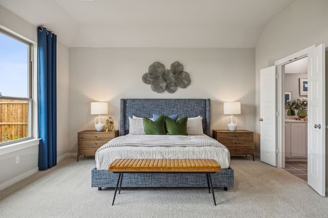 carpeted bedroom featuring vaulted ceiling and multiple windows