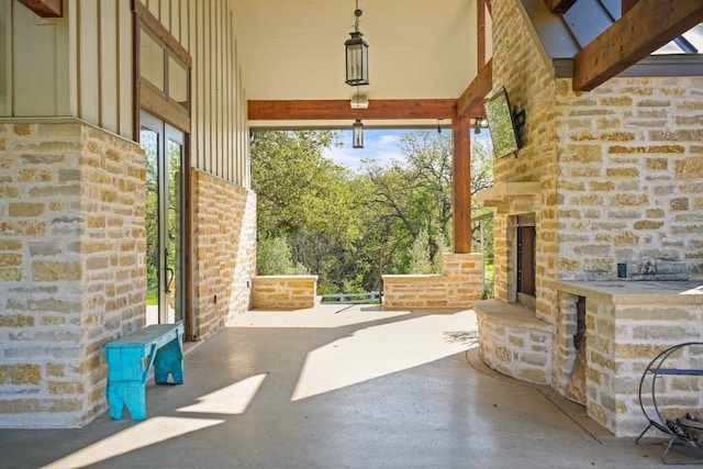 view of terrace featuring an outdoor stone fireplace