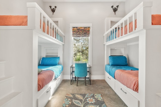 bedroom featuring concrete flooring