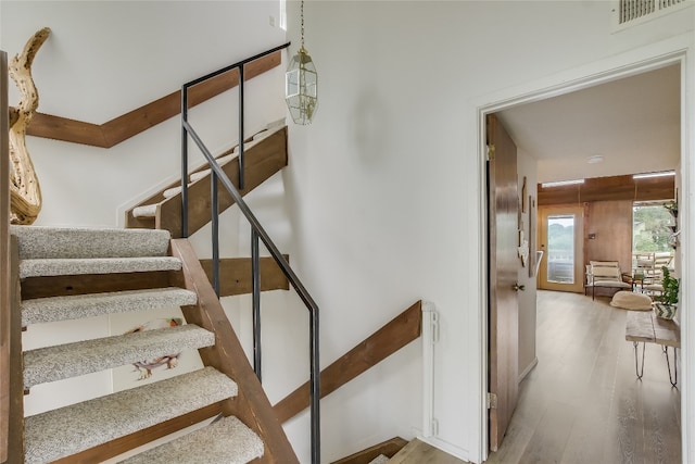 stairs with hardwood / wood-style floors