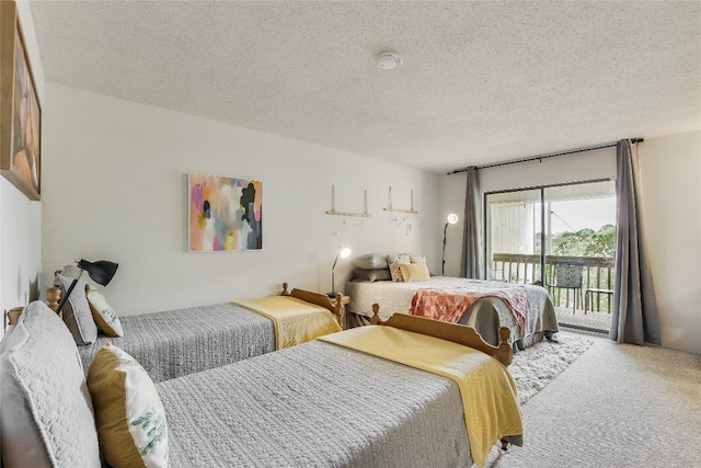 bedroom with carpet flooring, a textured ceiling, and access to outside