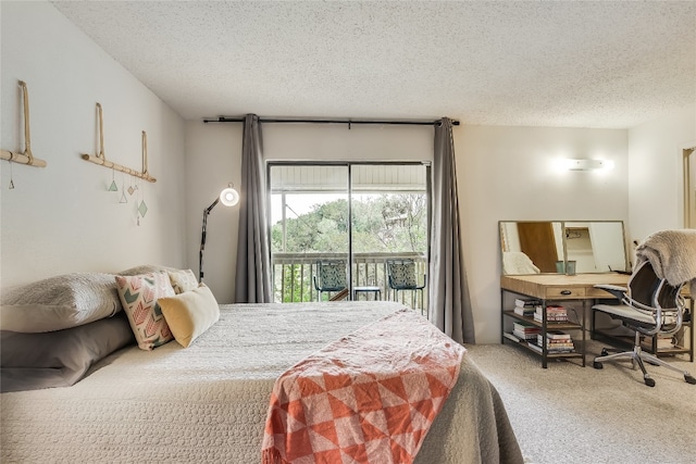 bedroom featuring access to outside, carpet, and a textured ceiling