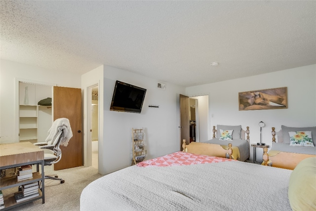 carpeted bedroom featuring a spacious closet, a closet, and a textured ceiling