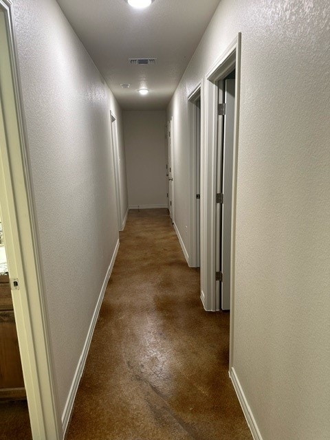 corridor featuring dark carpet