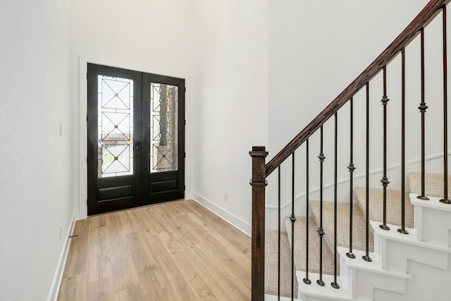 foyer with french doors and light wood-type flooring