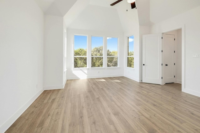 interior space with light hardwood / wood-style floors, high vaulted ceiling, and ceiling fan