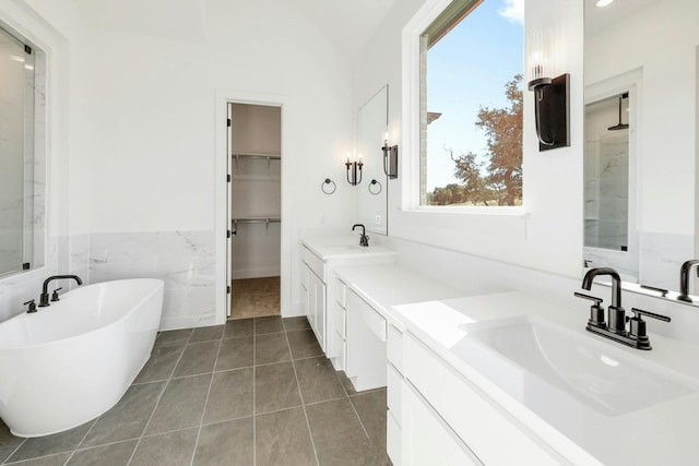 bathroom with vanity, lofted ceiling, tile patterned floors, and separate shower and tub