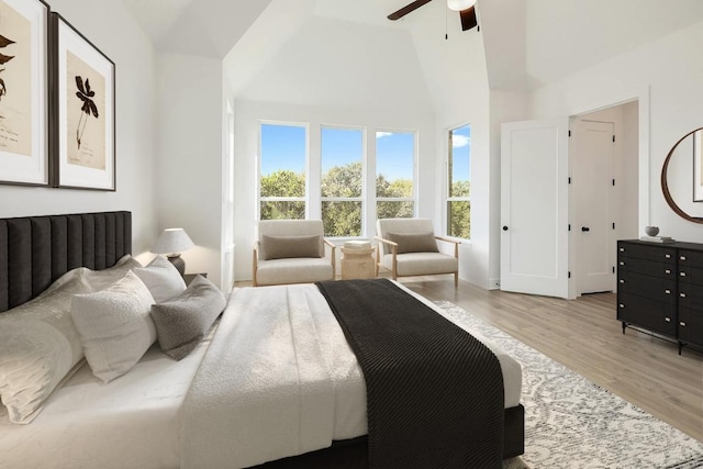 1221 Firebush Rd, Leander, TX 78641 - bedroom with high vaulted ceiling, light wood-style floors, multiple windows, and a ceiling fan