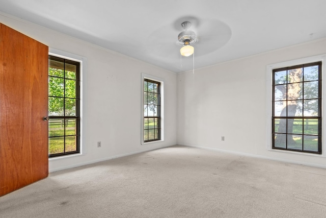 unfurnished room with ceiling fan and light colored carpet