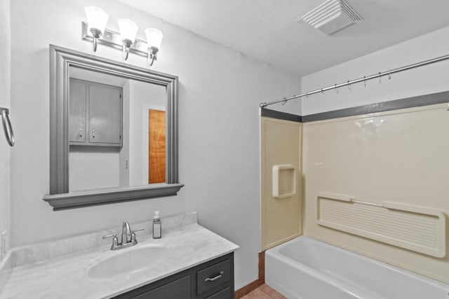 bathroom with tub / shower combination, a textured ceiling, and vanity