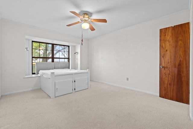 unfurnished bedroom with light carpet and ceiling fan