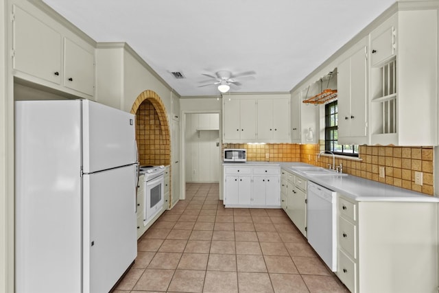 kitchen with ceiling fan, sink, tasteful backsplash, white appliances, and white cabinetry