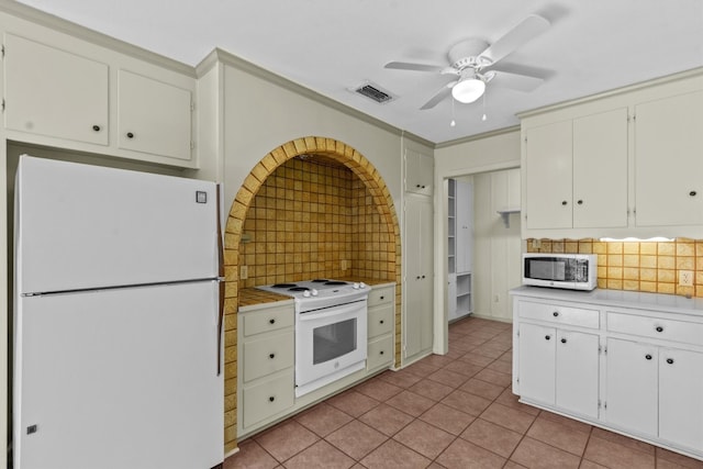 kitchen with white cabinetry, light tile patterned flooring, tasteful backsplash, white appliances, and ceiling fan