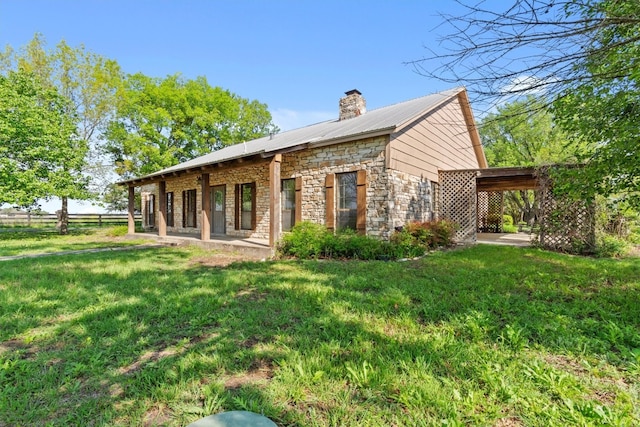 rear view of property with a lawn