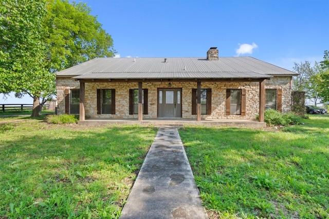 back of property featuring a yard