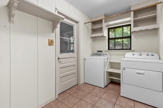 laundry room featuring independent washer and dryer and light tile patterned floors