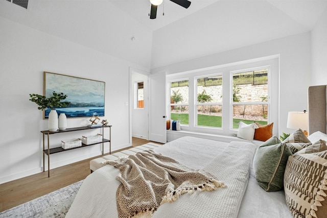 bedroom with high vaulted ceiling, hardwood / wood-style floors, and ceiling fan