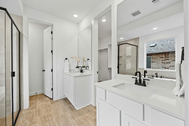 bathroom with vanity and an enclosed shower