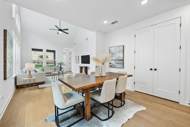 dining area featuring high vaulted ceiling, light hardwood / wood-style flooring, and ceiling fan