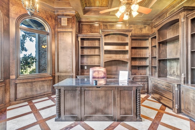 home office featuring ceiling fan with notable chandelier, crown molding, and wood walls