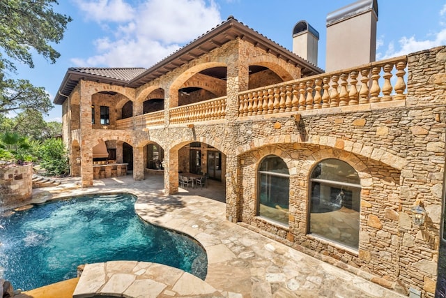 view of swimming pool with a patio area and pool water feature