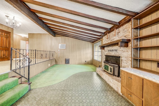 tiled living room featuring a textured ceiling, a fireplace, and wooden walls