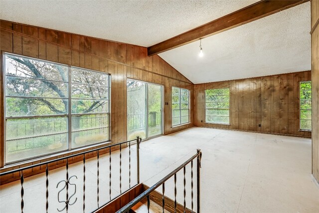 interior space with vaulted ceiling with beams