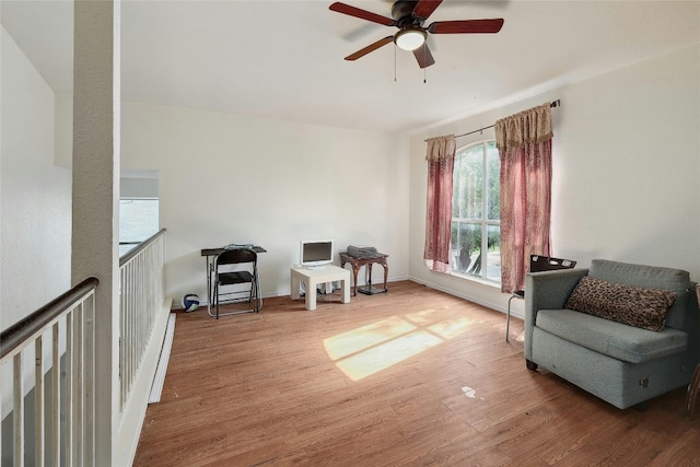 sitting room with dark hardwood / wood-style flooring and ceiling fan