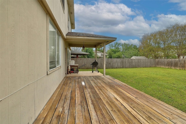 wooden deck with a lawn