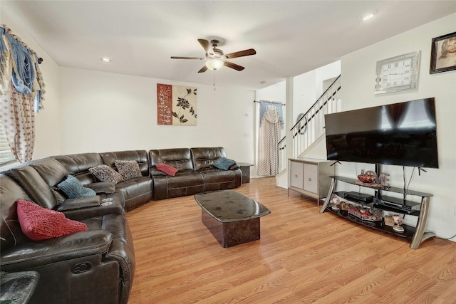 living room featuring ceiling fan and light hardwood / wood-style floors