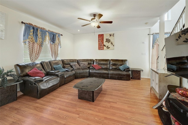 living room with ceiling fan and light wood-type flooring