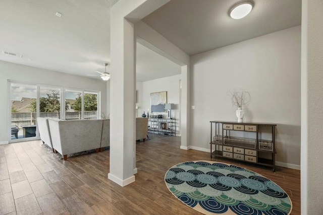 interior space with ceiling fan and wood-type flooring