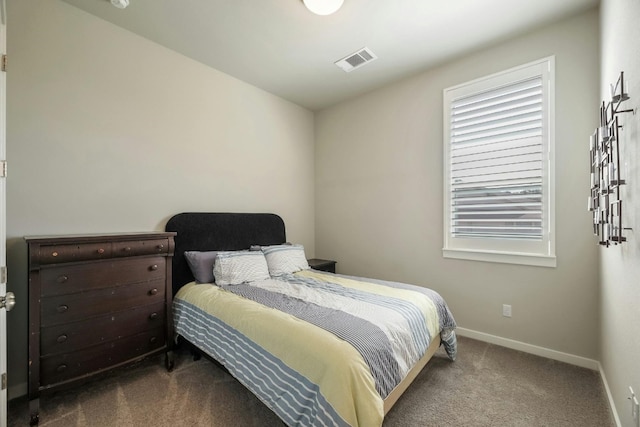 bedroom with dark colored carpet