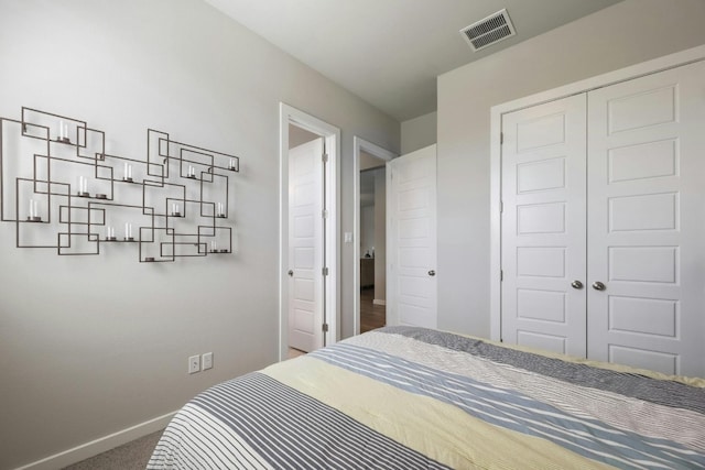 bedroom with a closet and dark colored carpet