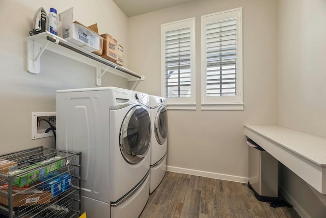 clothes washing area featuring washing machine and clothes dryer and dark hardwood / wood-style flooring