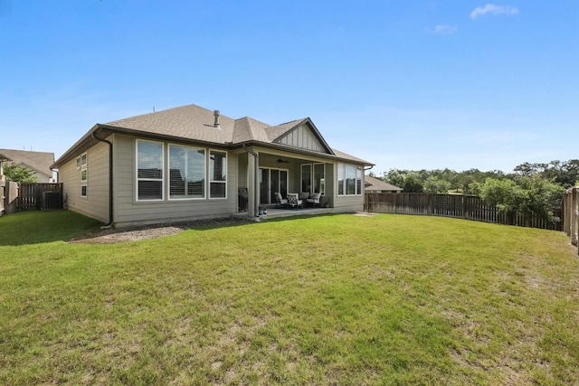 back of house with a yard and a patio