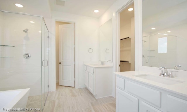 bathroom featuring tile floors, vanity with extensive cabinet space, and separate shower and tub