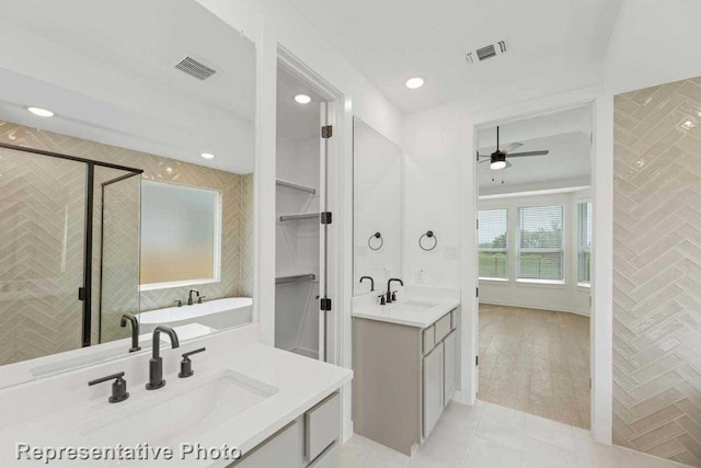 bathroom with ceiling fan, tile floors, dual vanity, and separate shower and tub