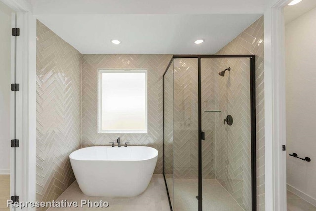 bathroom featuring tile walls, tile floors, and a shower with shower door