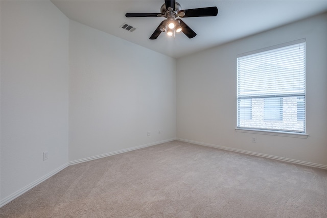 unfurnished room with a wealth of natural light, carpet, and ceiling fan