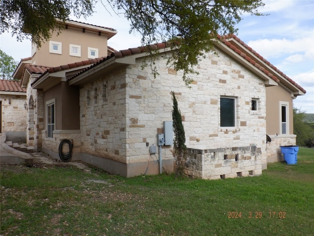 view of property exterior with a lawn