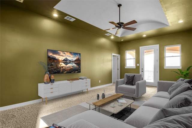 carpeted living room with ceiling fan